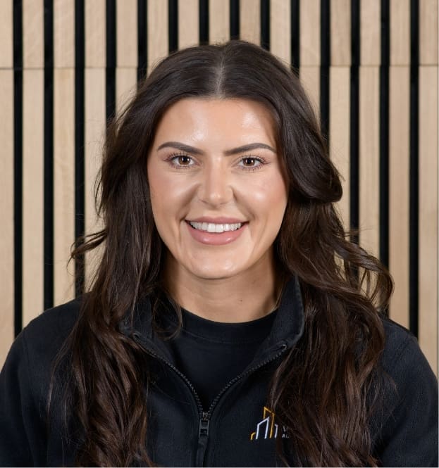 woman standing in front of a wooden wall